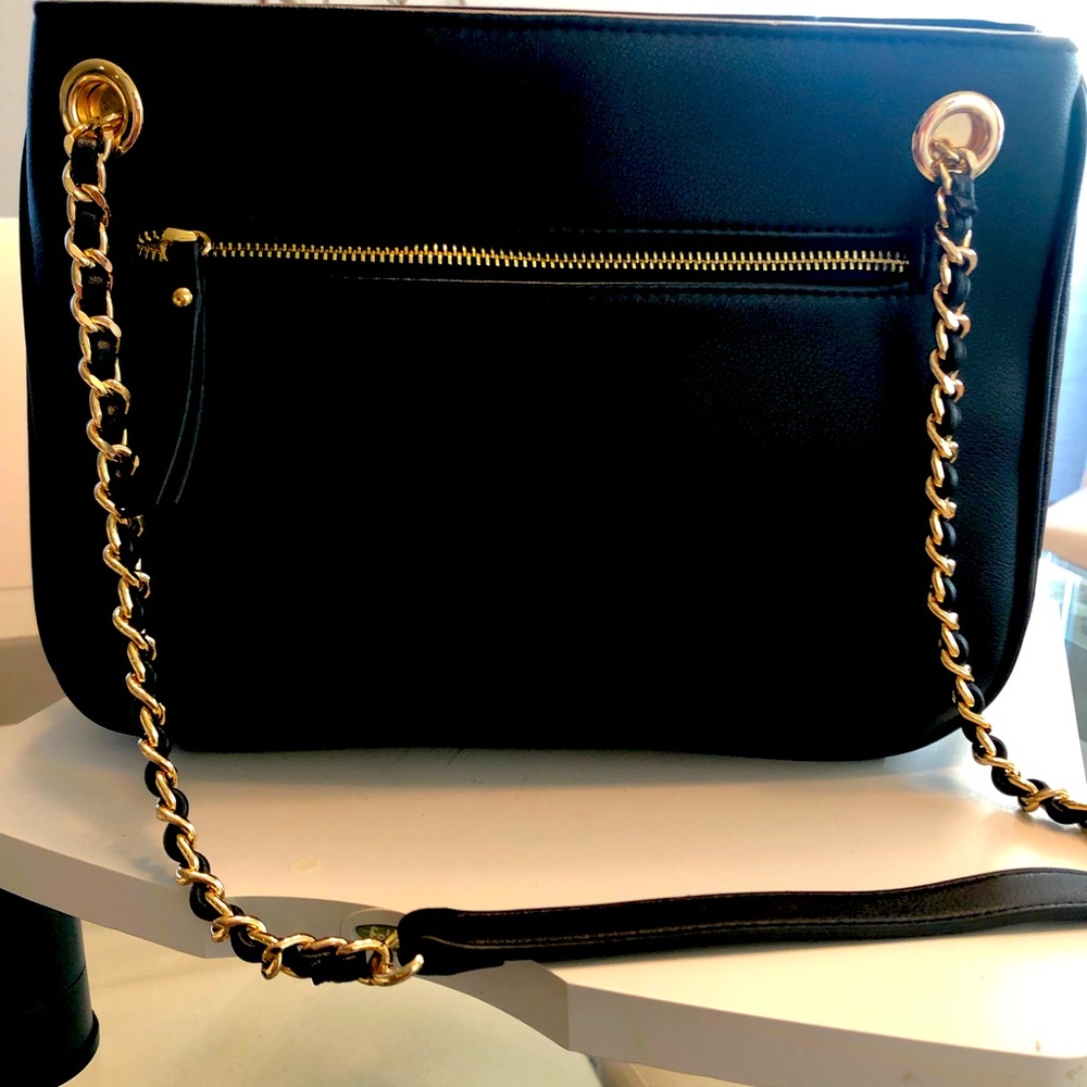 INC black shoulder bag. New w/tag. Snap top closure. Zippered sides that expand